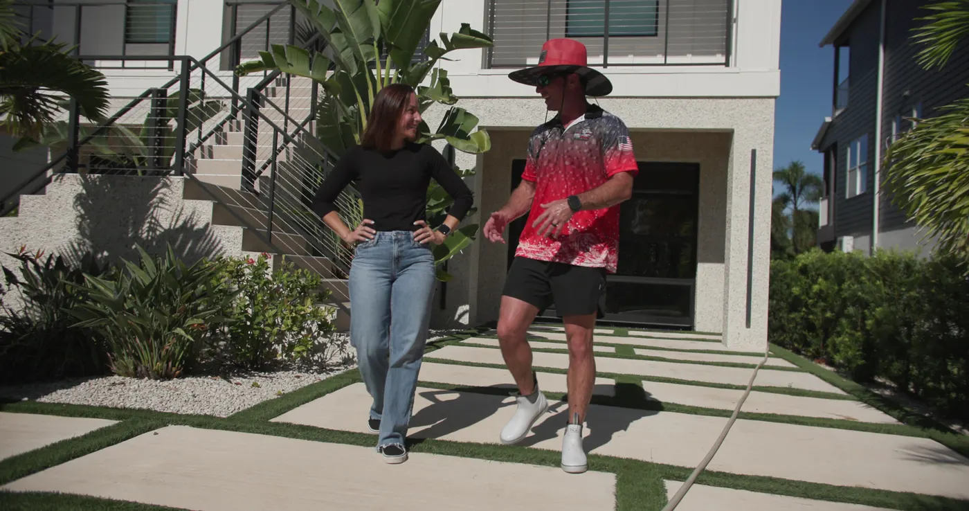 The husband-and-wife owners of Iron Shield walking up to a Hudson home together at the start of a job