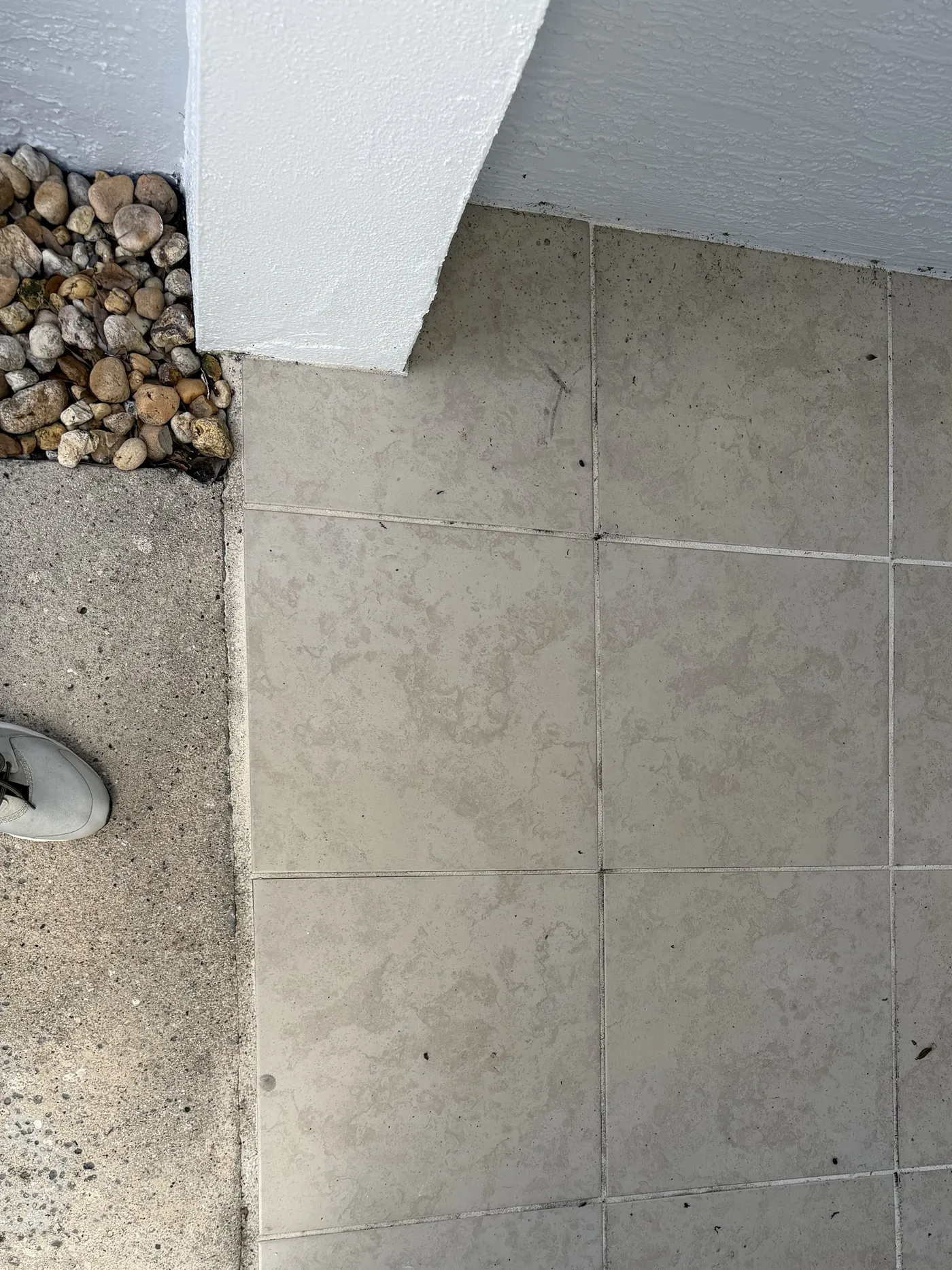 The same outdoor tile entryway after cleaning, with the staining lifted from the tile and grout