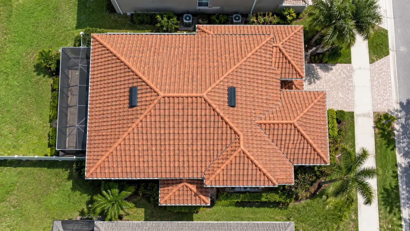 Top-down aerial view of a completed terracotta tile roof cleaning on a Hudson home